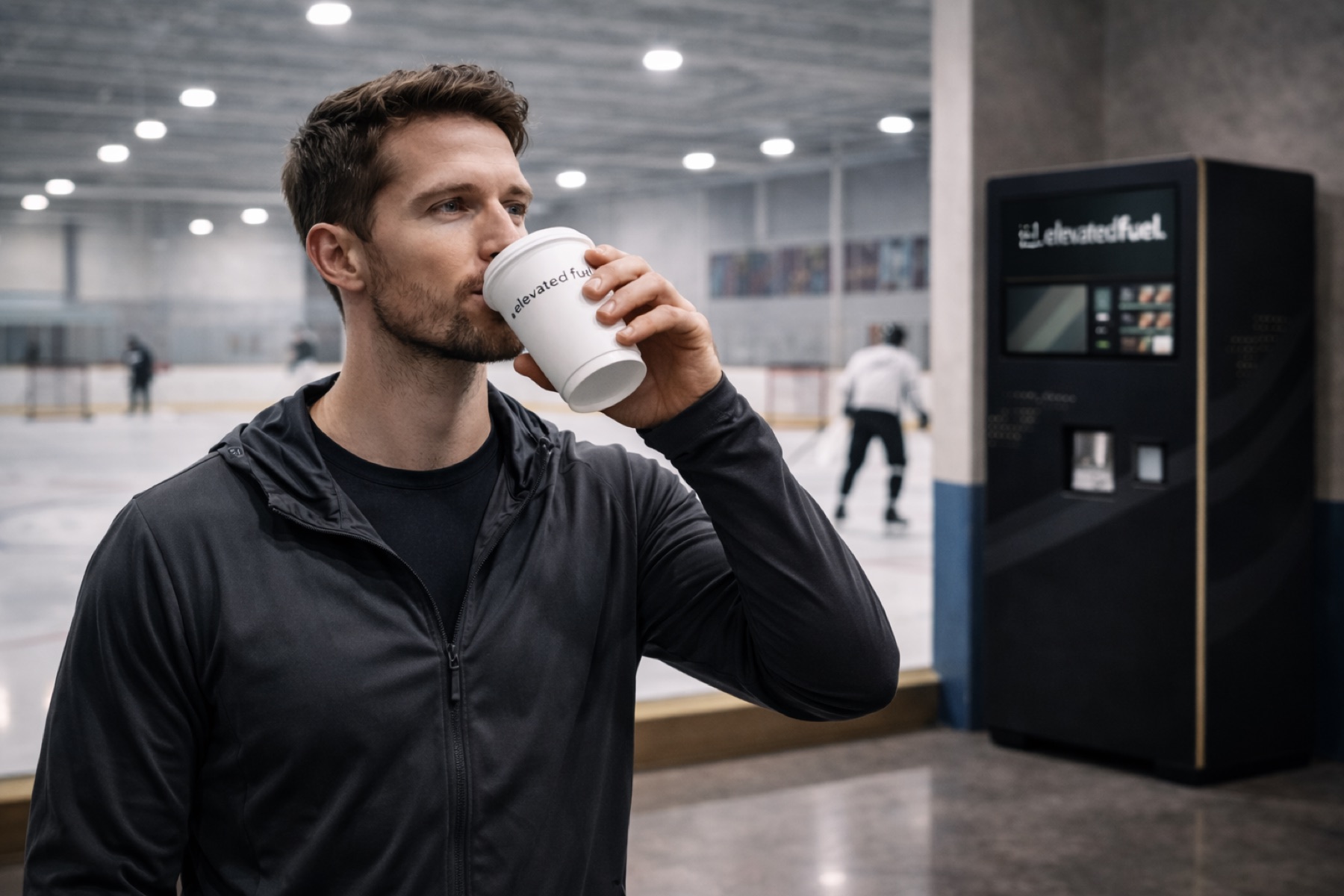 Person drinking an Elevated Fuel shake at a sports facility